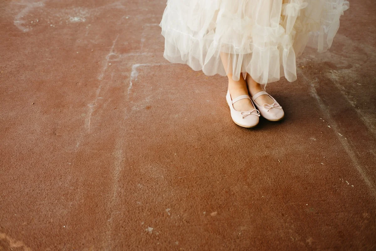Balletcore aesthetic outfit with satin ballet flats, tulle, and soft pink tones