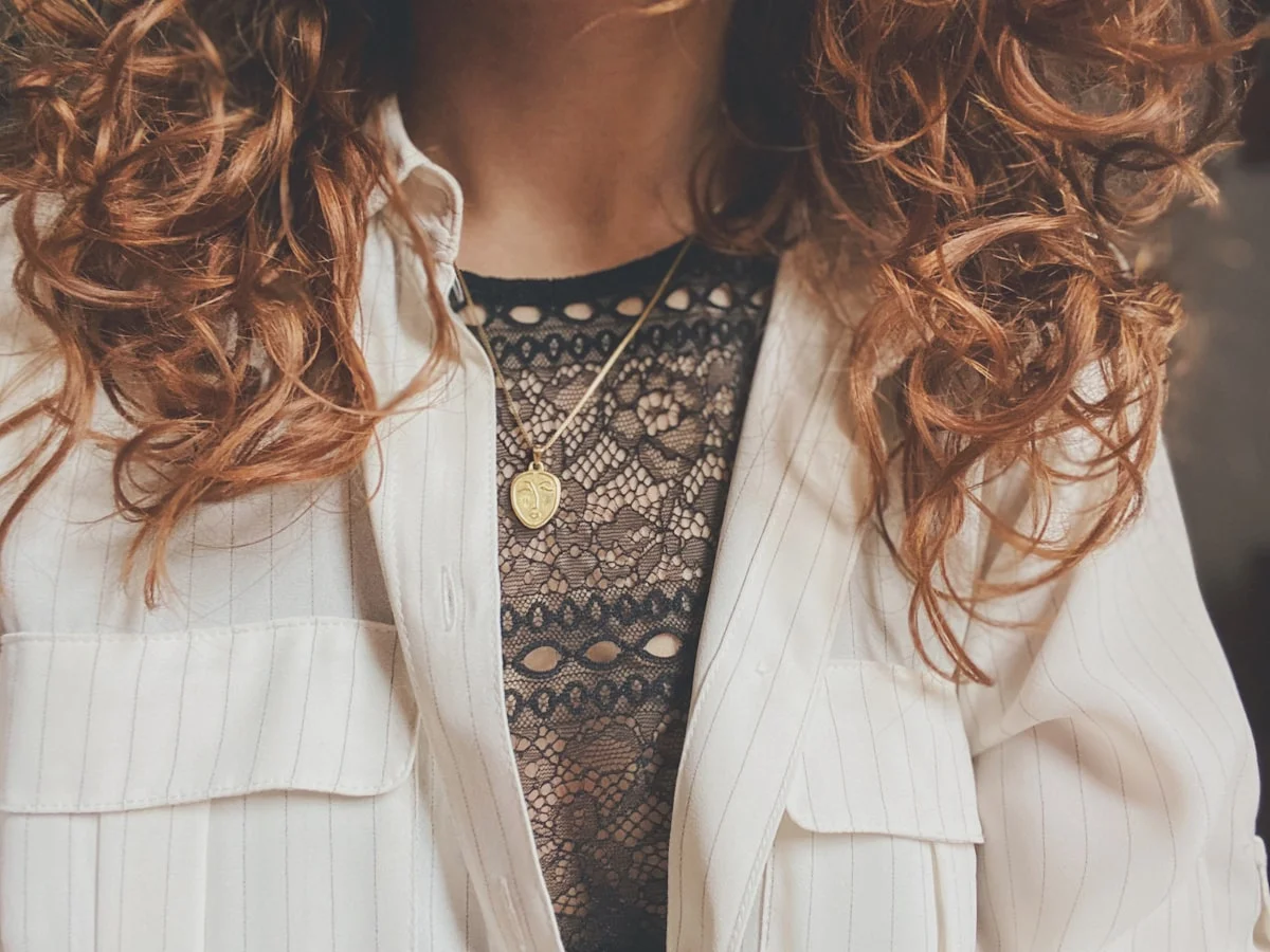 Clean girl styling details: white tee, delicate gold jewelry, and neutral tones
