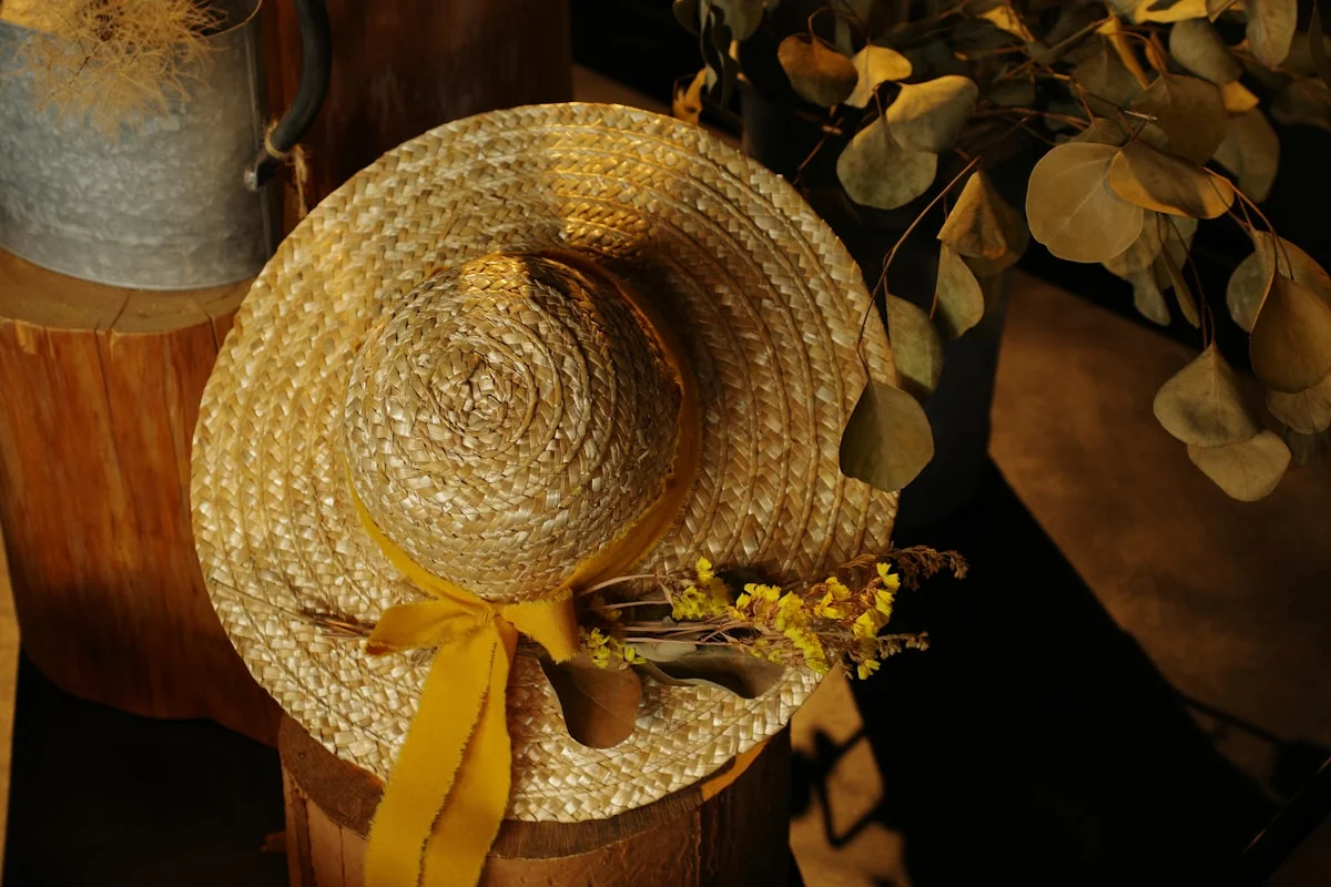 Cottagecore styling details: linen fabric, wildflowers, and a straw hat