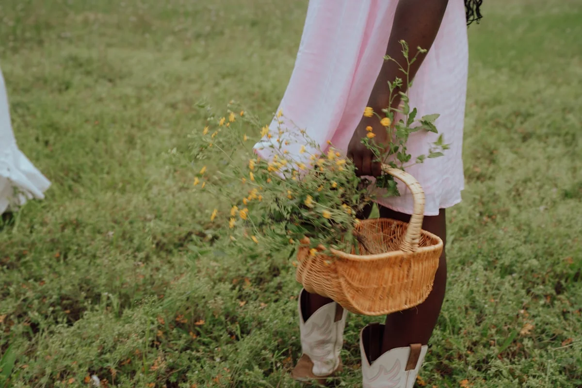 Cottagecore aesthetic outfit with a floral dress in a natural meadow setting
