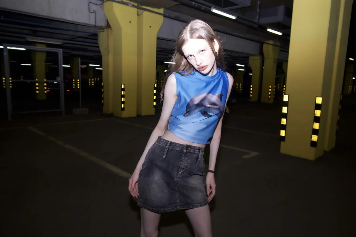 Y2K styling details: metallic fabric, denim, and a fitted baby tee