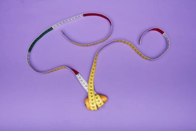 Measuring tape being used to measure waist for body shape determination