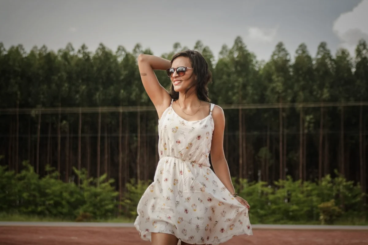 Woman wearing a breathable summer capsule wardrobe outfit with a linen sundress