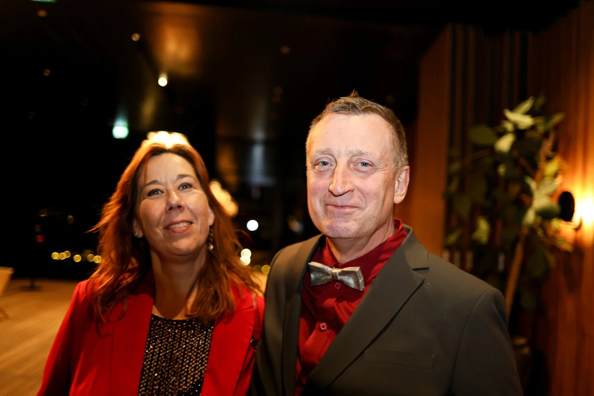 Guests in black tie formal wear at an evening gala