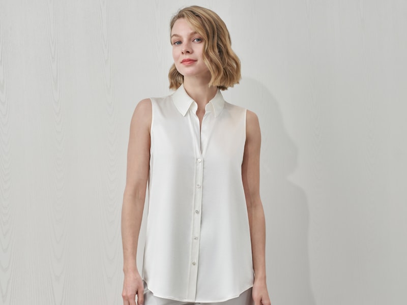 Woman wearing a business casual outfit with tailored trousers and a blouse