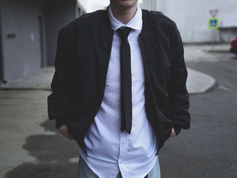 Man wearing a creative black tie tuxedo with a personalized jacket detail