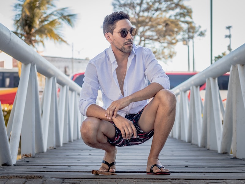 Man in a linen button-down and chinos at a resort terrace
