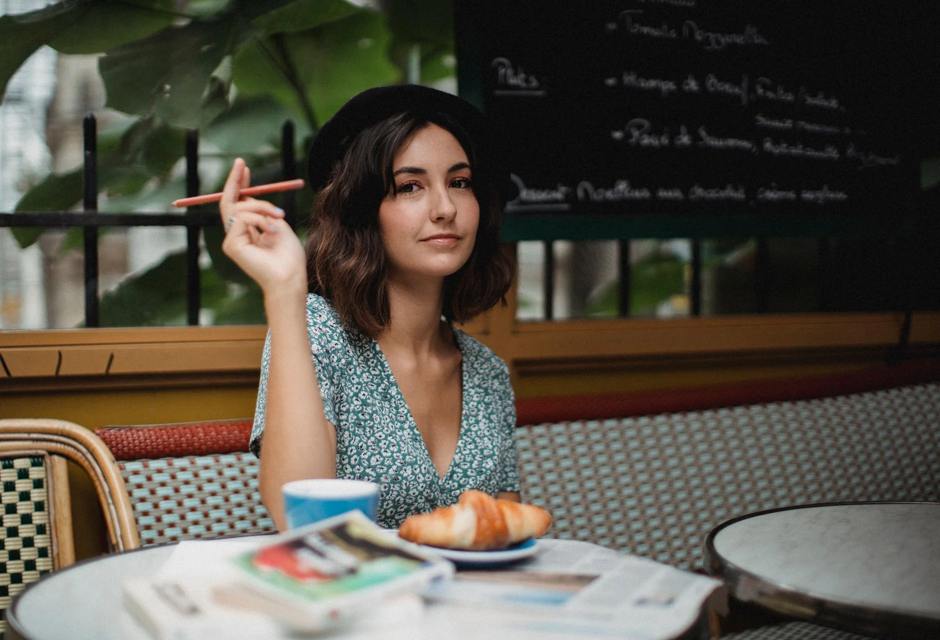 Woman in a brunch outfit with a midi dress at a cafe