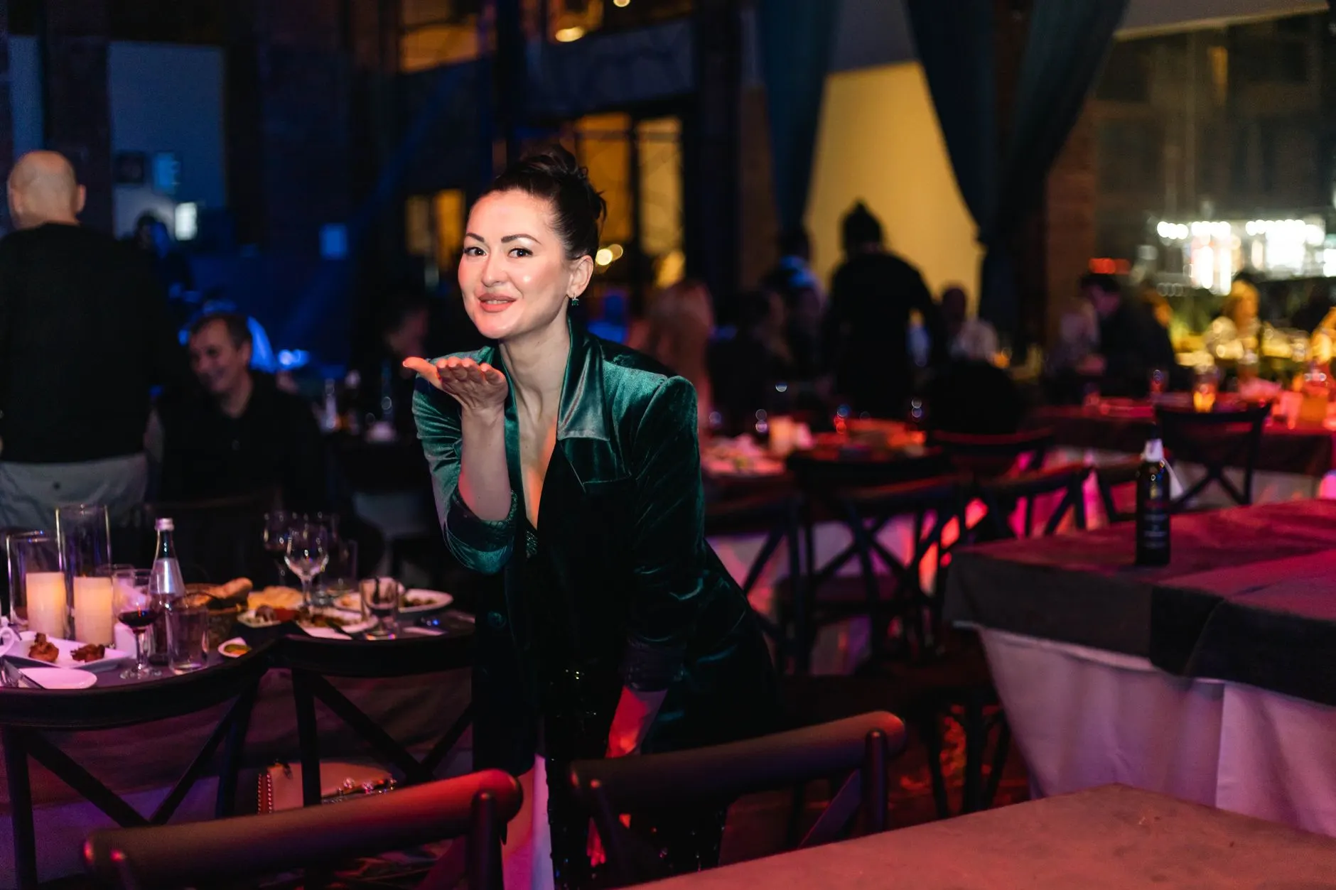 Woman in a velvet emerald dress at a festive Christmas party