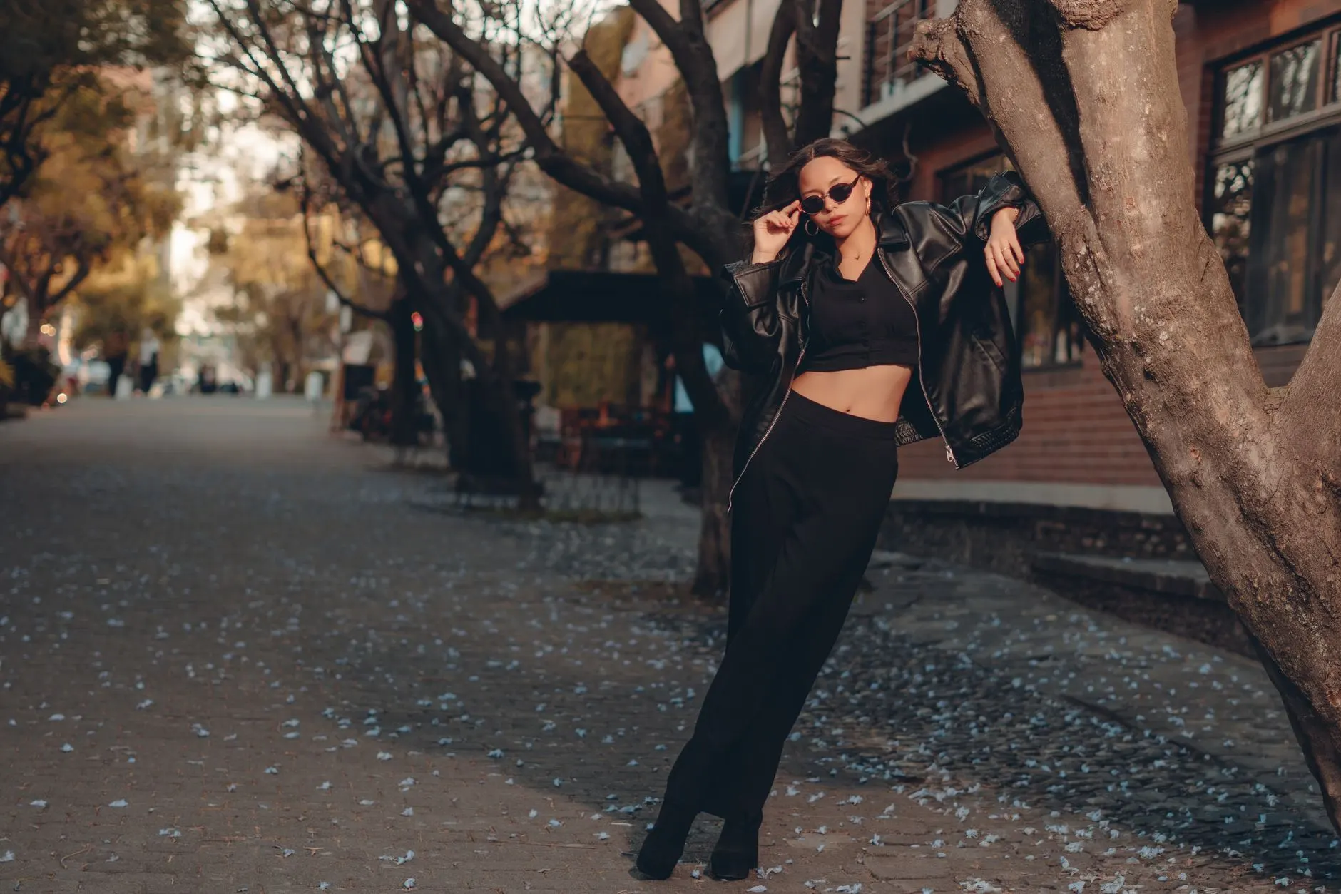 Woman in a black outfit and oversized leather jacket for a date night out