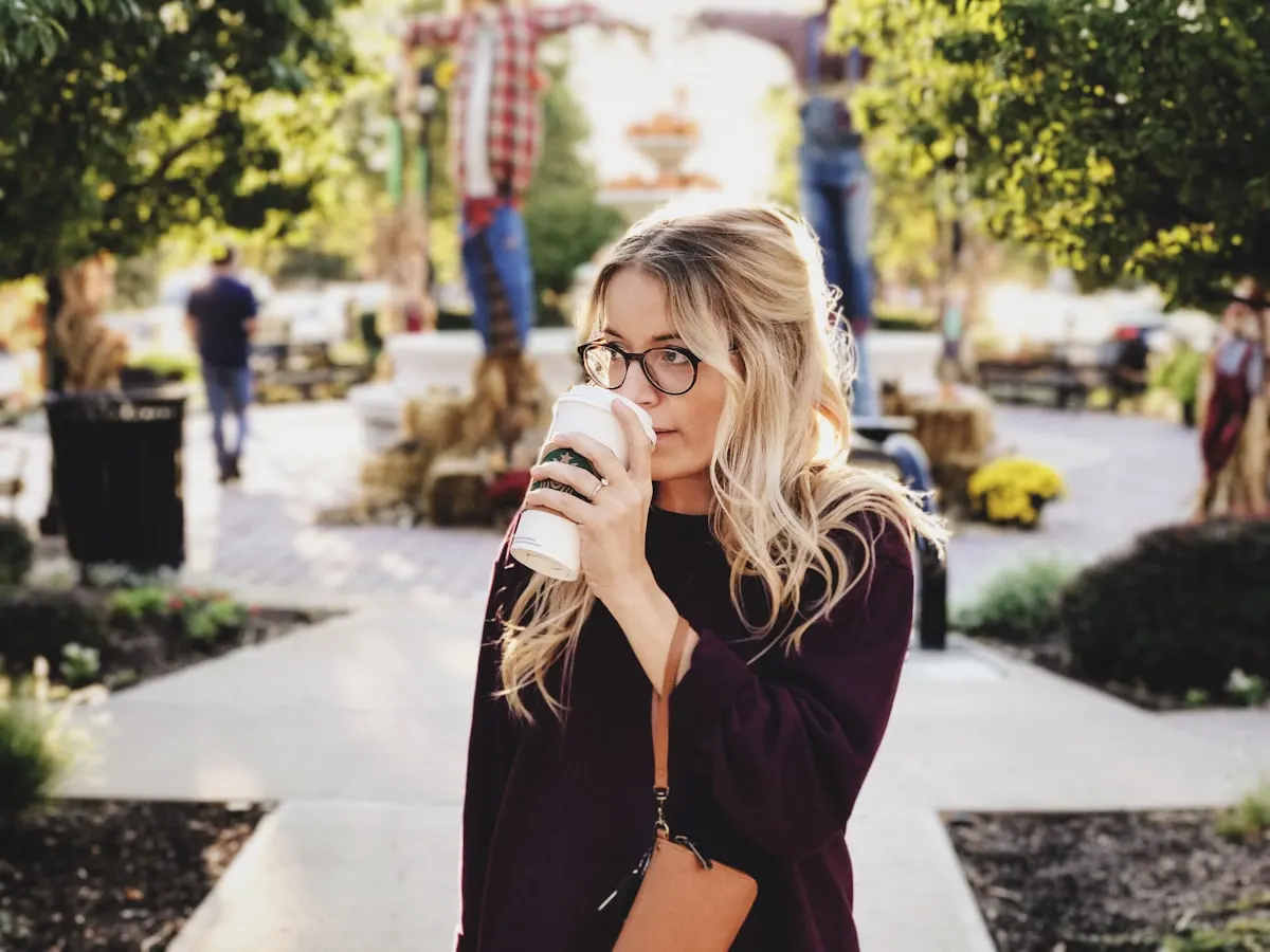 Woman in a cozy sweater sipping coffee on a casual daytime date