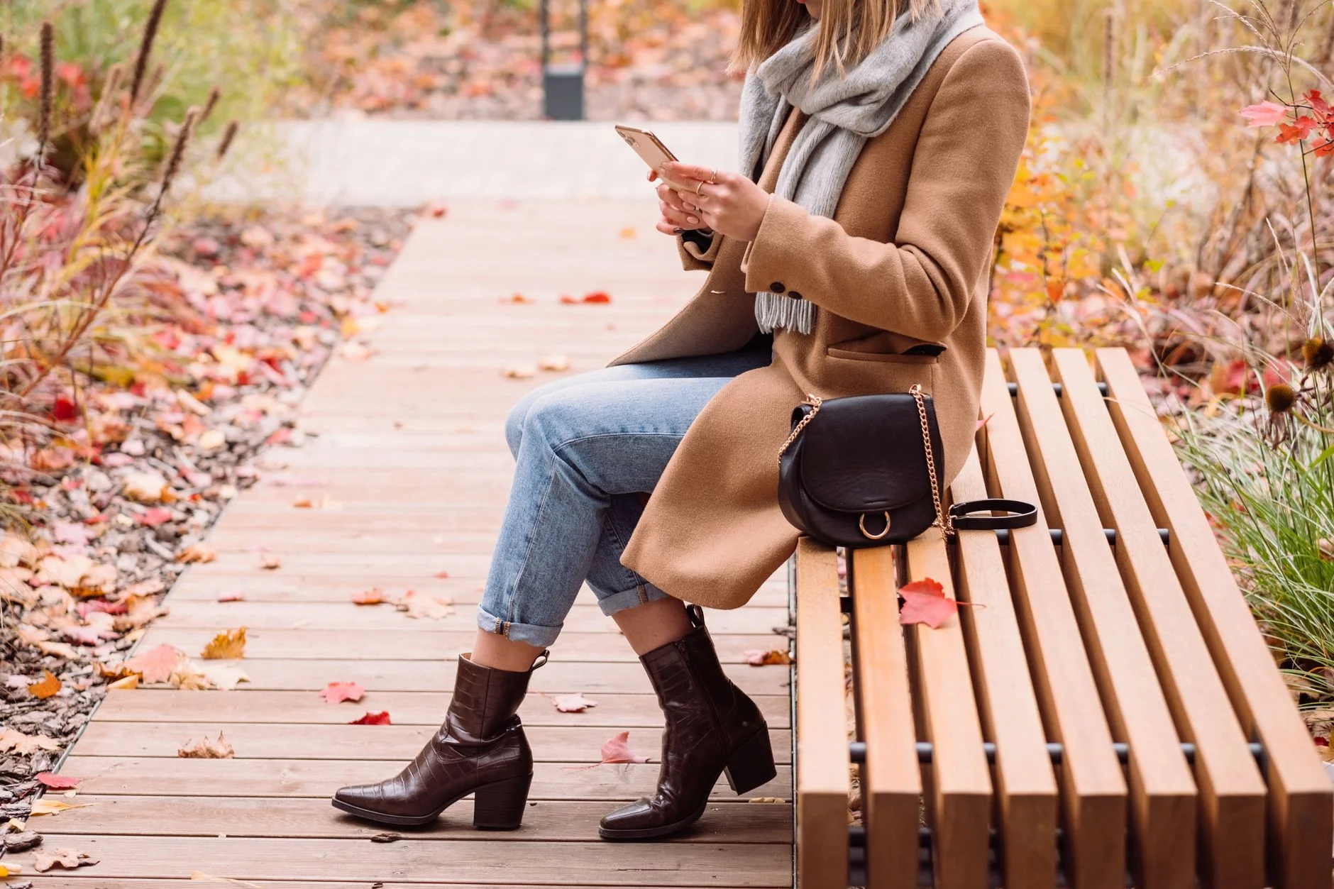 Woman in a fall outfit with brown coat and autumn layers