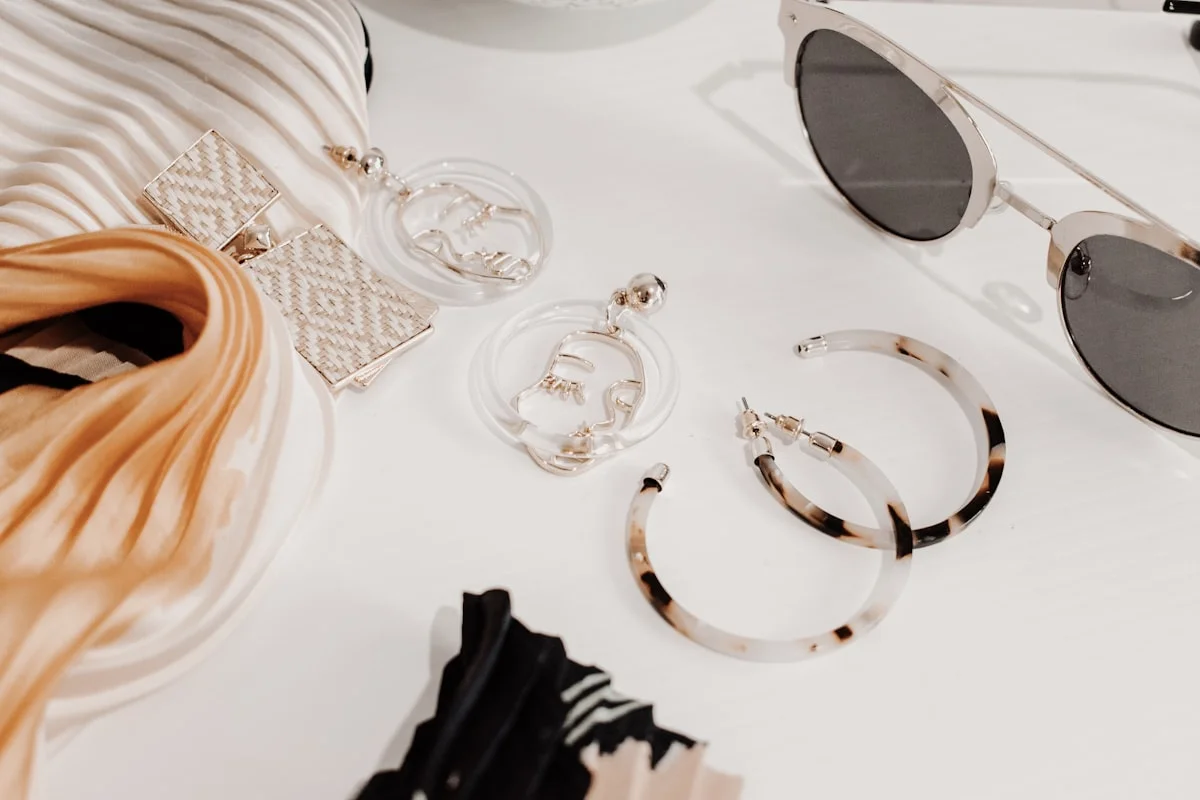 Seasonal outfit ideas laid out with layering pieces and accessories