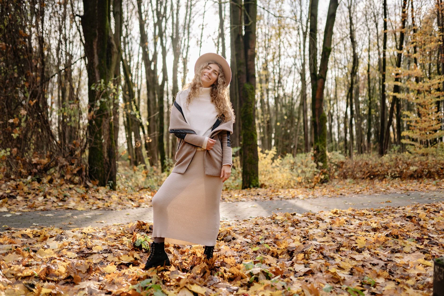 Woman in a cozy sweater and dress Thanksgiving outfit