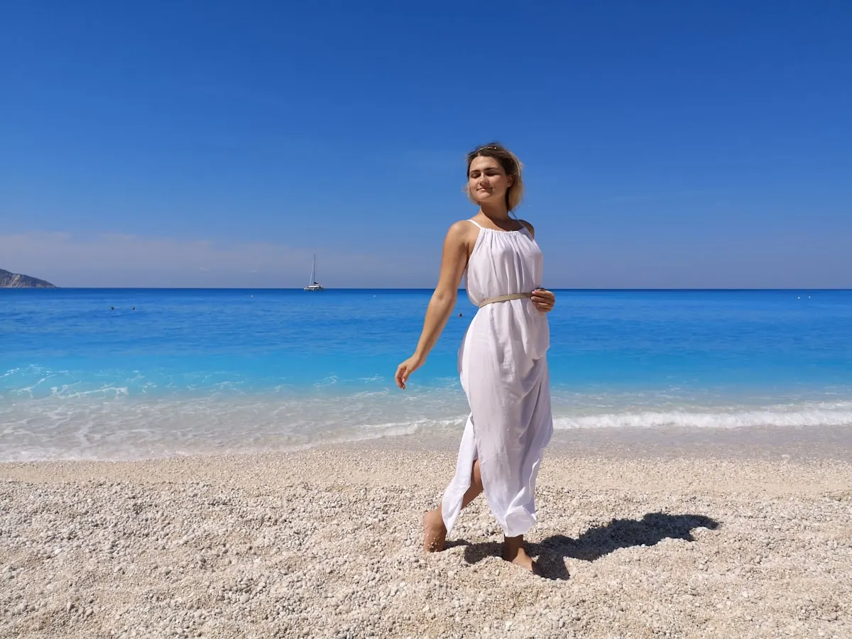 Woman in a flowing linen maxi dress at an outdoor beach wedding