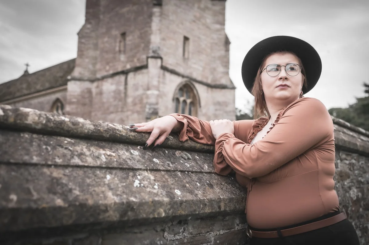 Woman in a modest smart casual dress and cardigan for a church christening