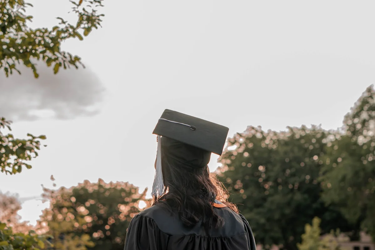 Woman in a smart blazer and dress attending a graduation ceremony