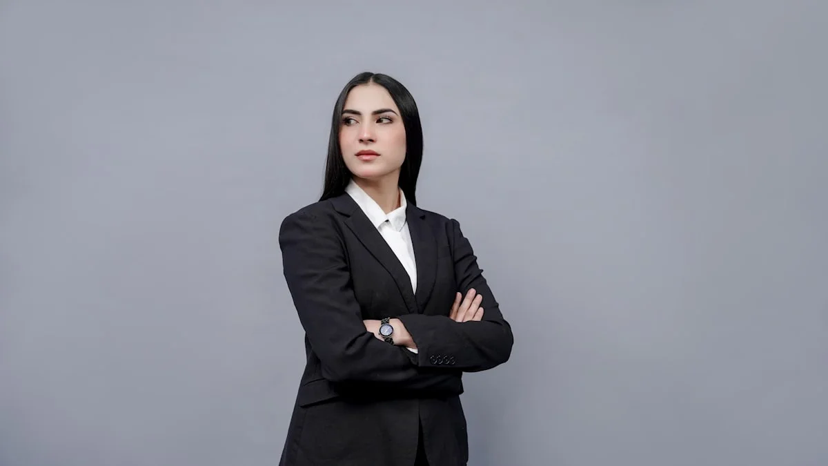 Woman in a tailored navy blazer and blouse dressed for a job interview